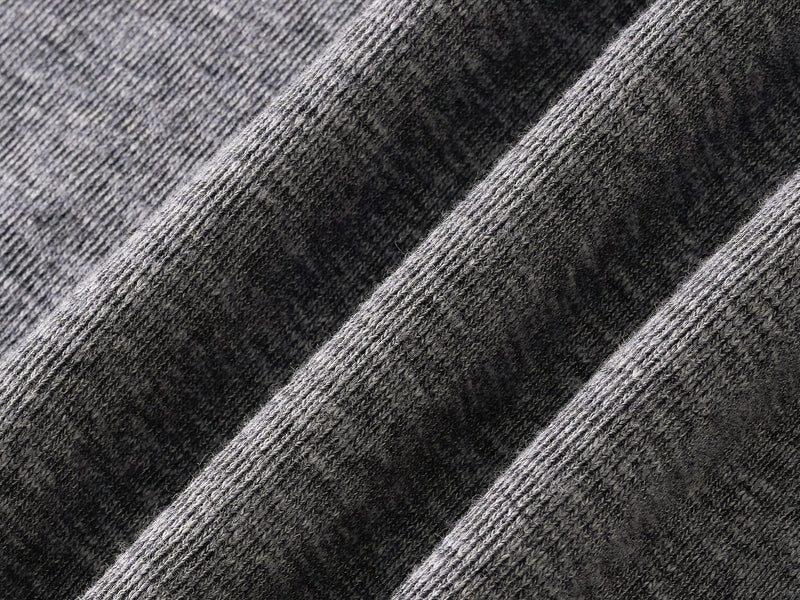 Close-up of gray tee fabric folds showing soft heathered knit texture