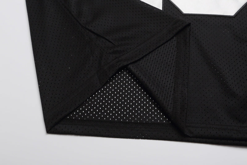 Black mesh varsity football jersey T-shirt with visible hem and textured perforated fabric detail
