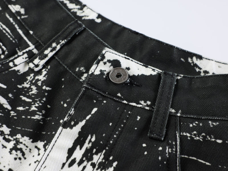 Close-up of jeans waistband button and belt loop on black and white animal print denim