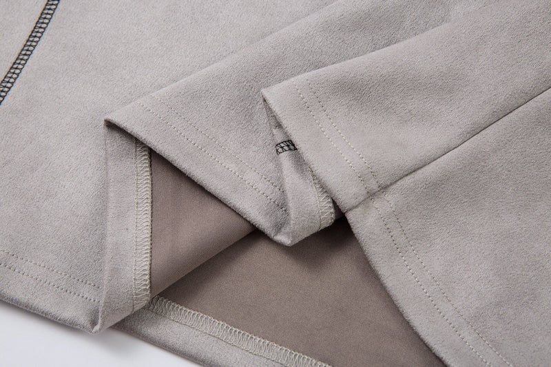 Close-up of sleeve cuff and inner seam finishing on the light gray polo shirt
