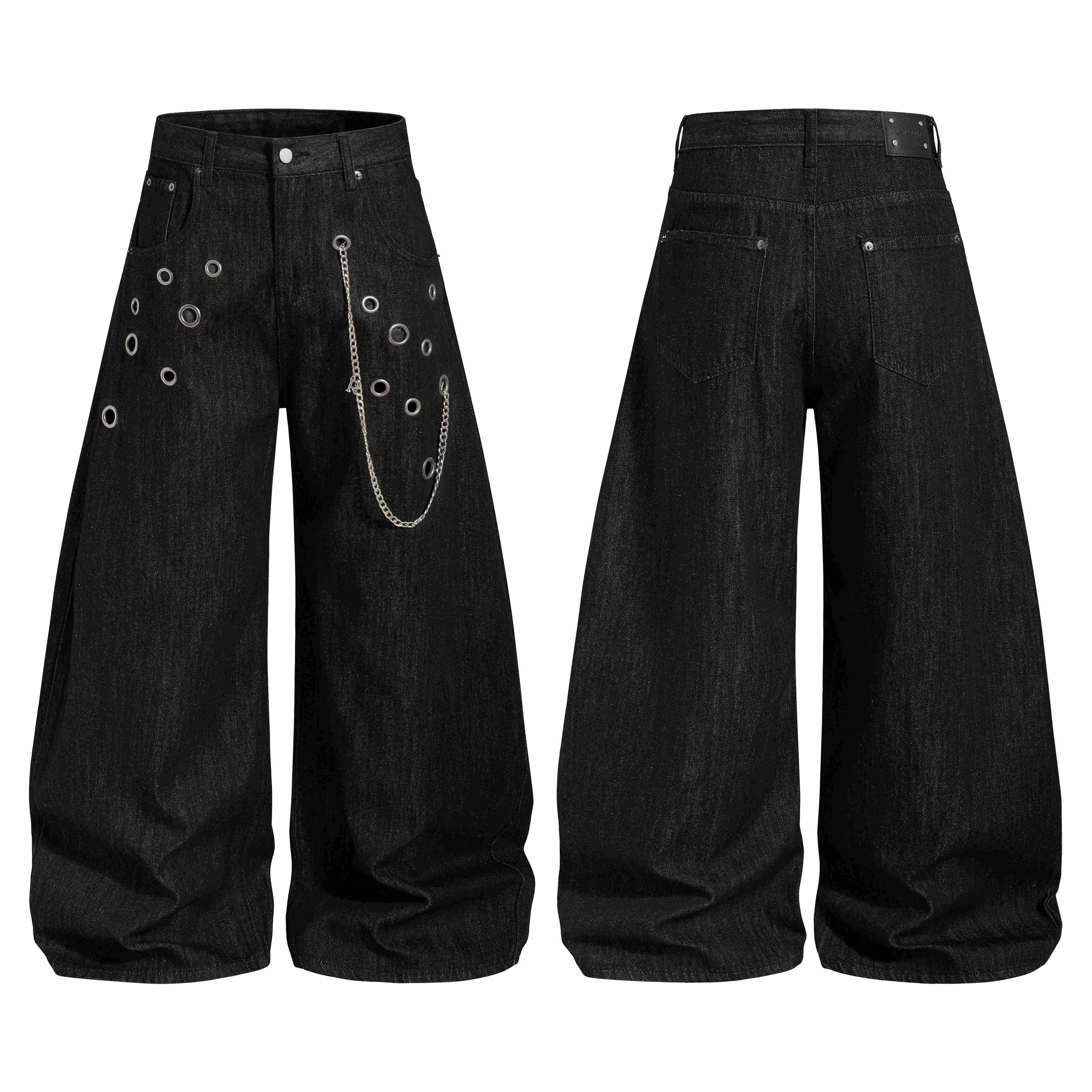 Front and back view of black wide-leg denim pants with scattered metal eyelets and a silver detachable chain on the front pan