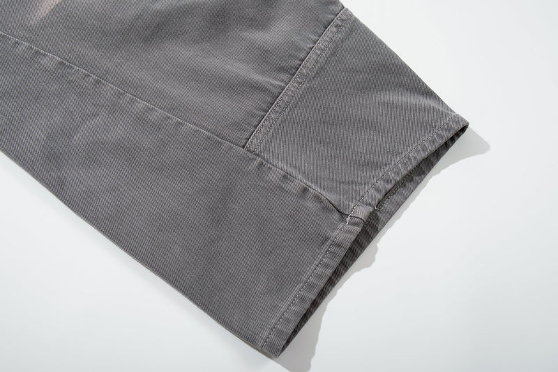Close-up of gray jeans lower leg hem and seam stitching