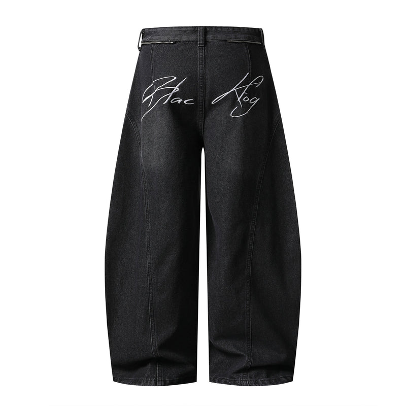 Black wide-leg jeans with white script and back zip pockets, back view
