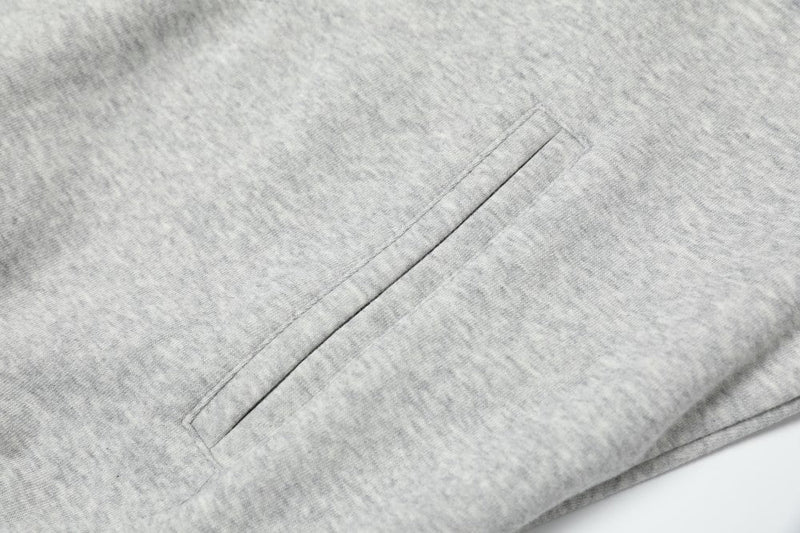 Close-up of side seam pocket on gray hoodie fabric
