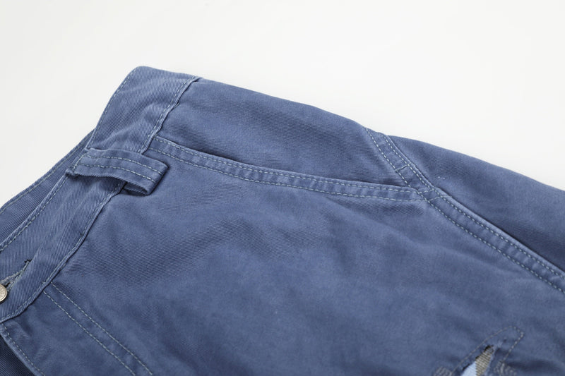 Close-up of blue cargo shorts upper side with belt loop and seam stitching
