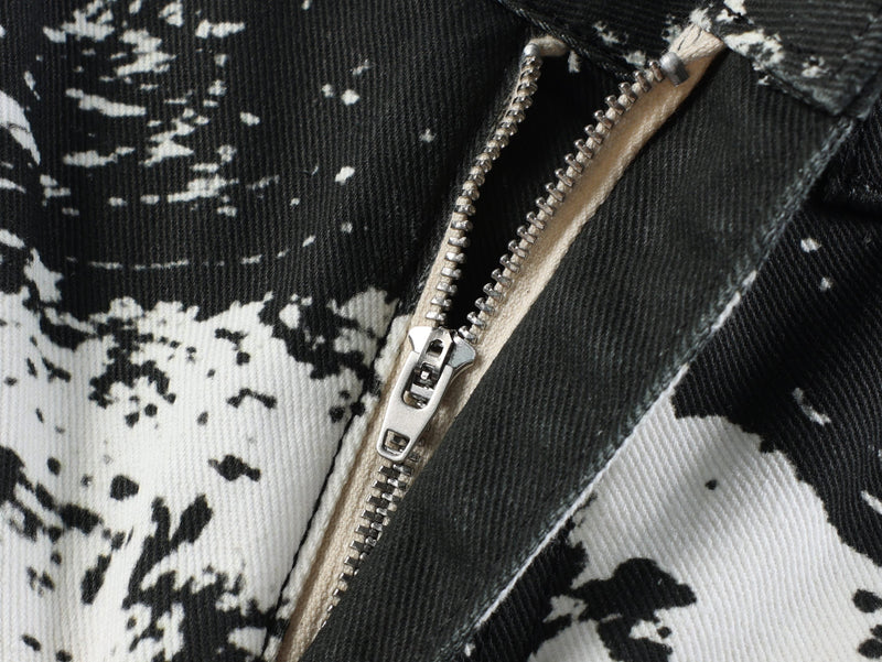Close-up of front zipper on black and white animal print jeans