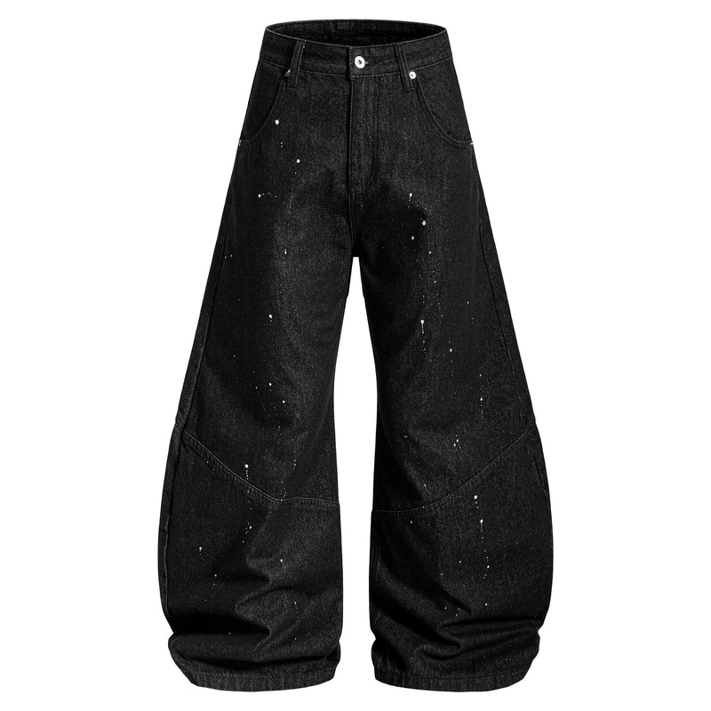 Black wide-leg jeans with white paint splatter, front view
