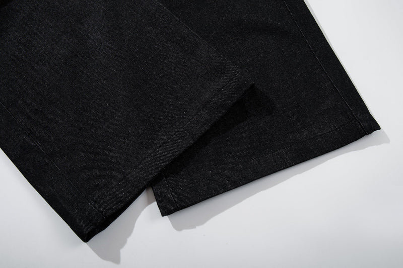 Close-up of hem on black wide-leg denim pants with clean straight stitching
