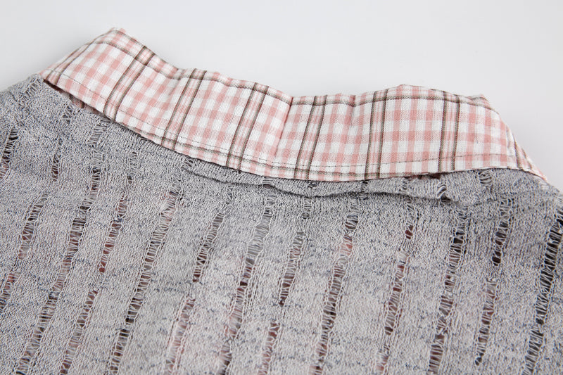 Close-up of pink plaid collar against gray sheer mesh neckline