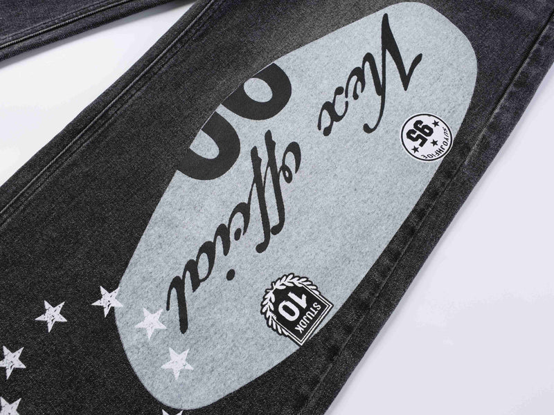 Close-up of black denim leg with gray oval graphic and star print