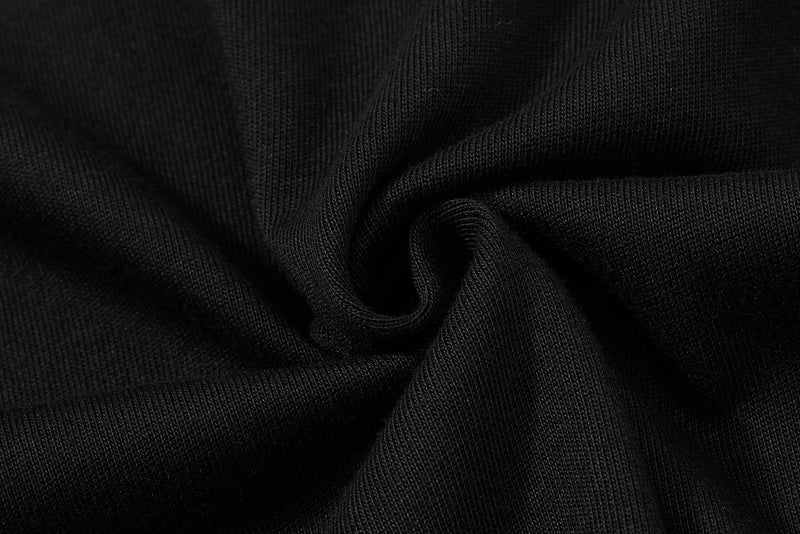 Close-up of black ribbed knit fabric with soft folds, highlighting the texture of a streetwear polo tee
