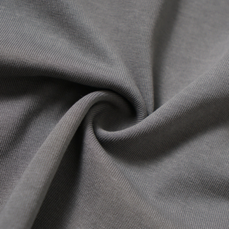 Close-up of soft washed grey knit fabric gathered into folds