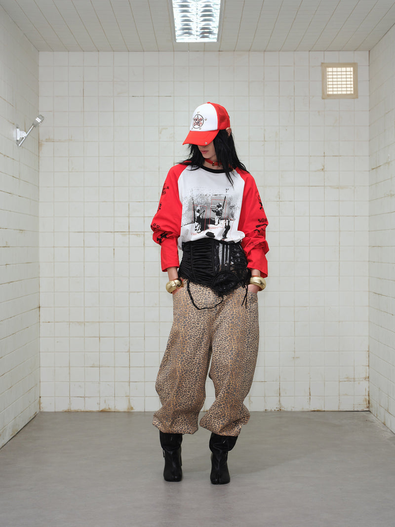 Model facing down in red and white graphic raglan long-sleeve T-shirt