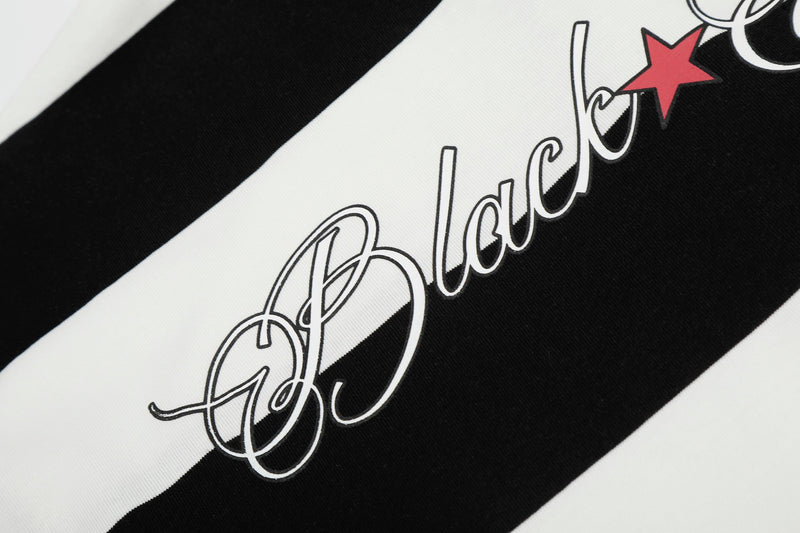 Black and white rugby stripe polo shirt with bold script logo and red star graphic detail
