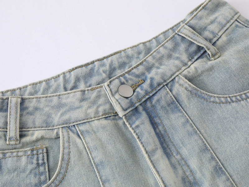 Close-up of the waistband with belt loops, button closure, and faded denim texture