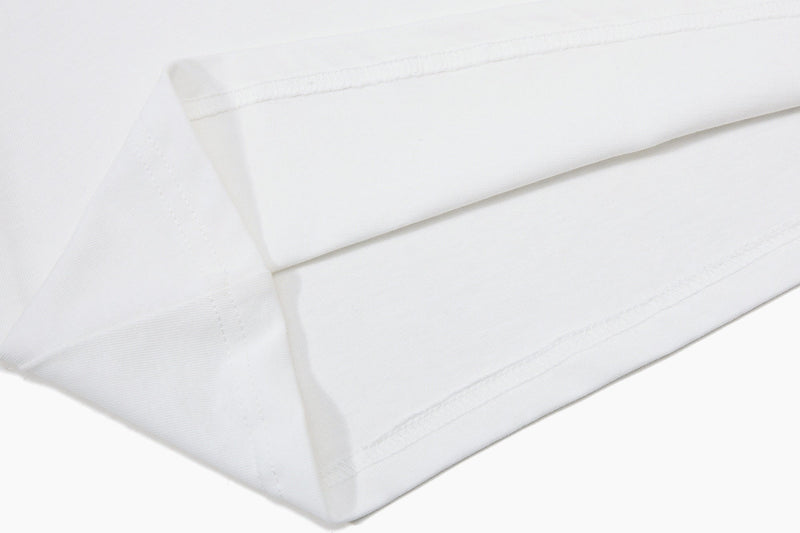Close-up of folded white polo shirt sleeve with clean stitched hem and textured fabric detail