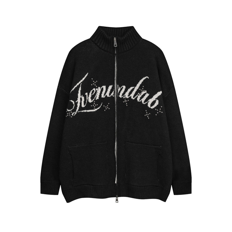 Black knit zip cardigan with white script lettering and studded eye graphic on the front