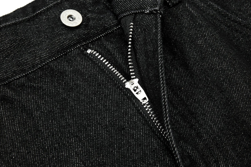 Close-up of black jeans fly with silver zipper and button