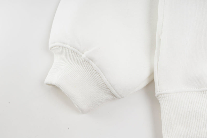 Close-up of white hoodie sleeve cuff and ribbed hem detail