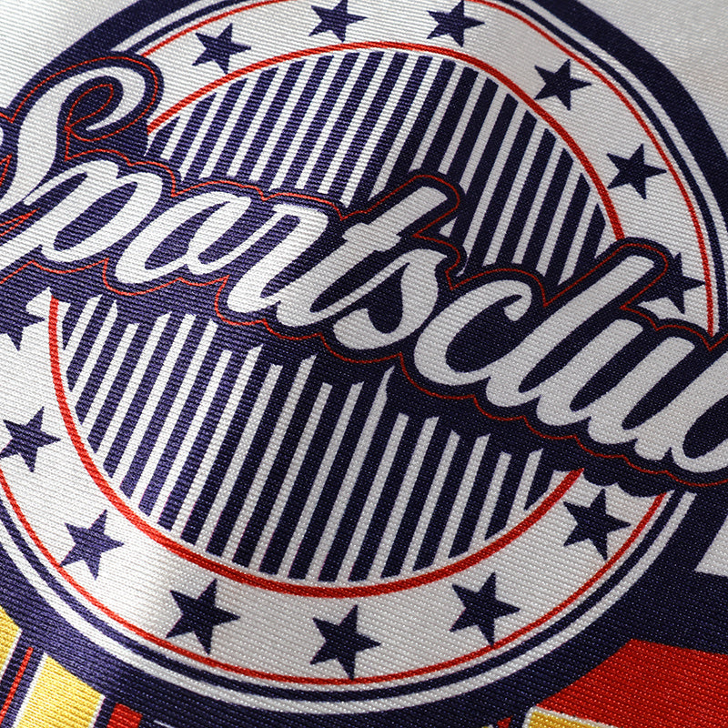 Close-up of Americana Sportsclub street jersey graphic with varsity-style script, stars, and red, white, and navy stripes