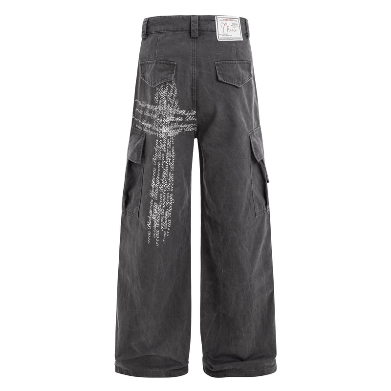 Back view of black cargo pants with rear pockets and white cross script graphic