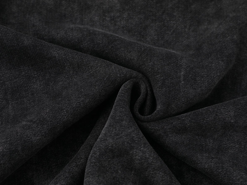 Close-up of dark fabric texture with soft folded drape
