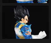 The Seakoff Vegeta Collectible Figure from Dragon Ball Z stands at 45cm with spiked black hair, a blue and gold armor suit with visible tears, and captures a dynamic pose. It includes 4 interchangeable heads showcasing various Super Saiyan forms against a black background.