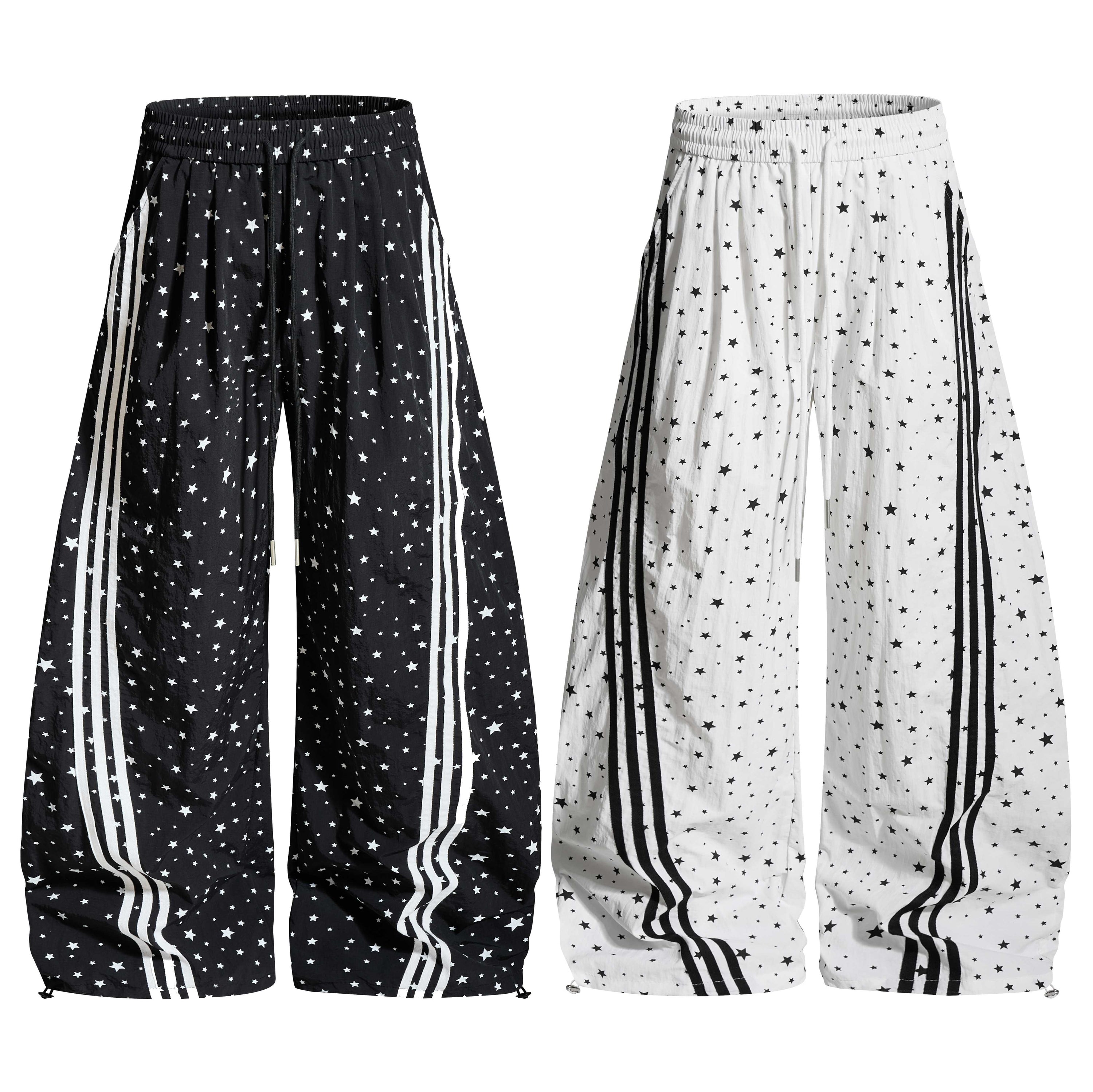Black and white wide-leg track pants with all-over star print and contrast side stripes, shown in both colorways