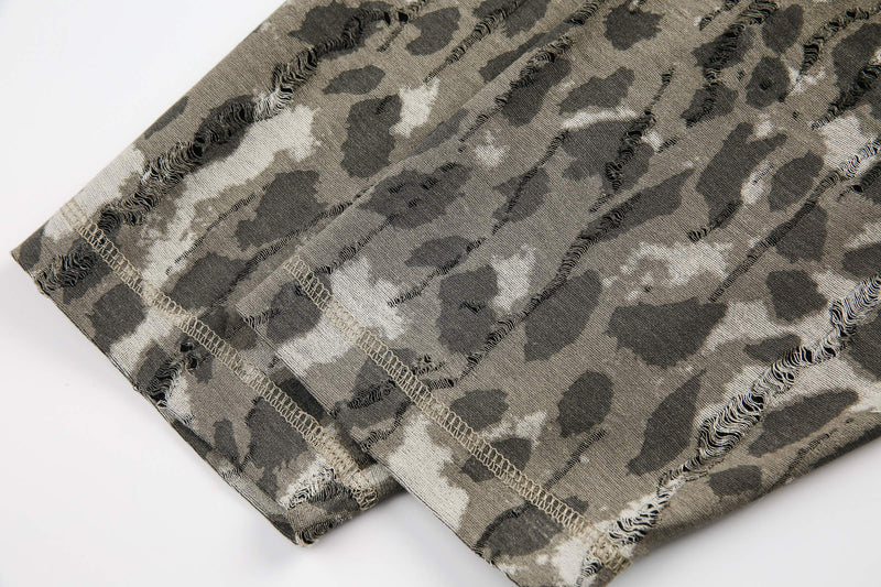 Close-up of camouflage sleeve cuff with distressed seams and stitched hem