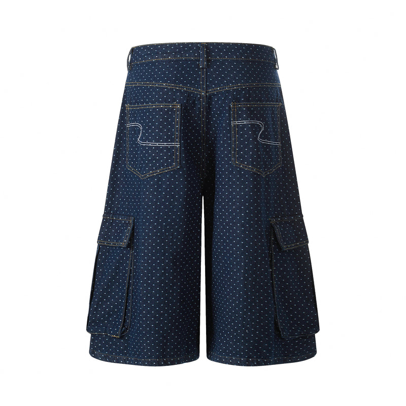 Back view of navy polka dot denim cargo shorts with large patch pockets and wide legs