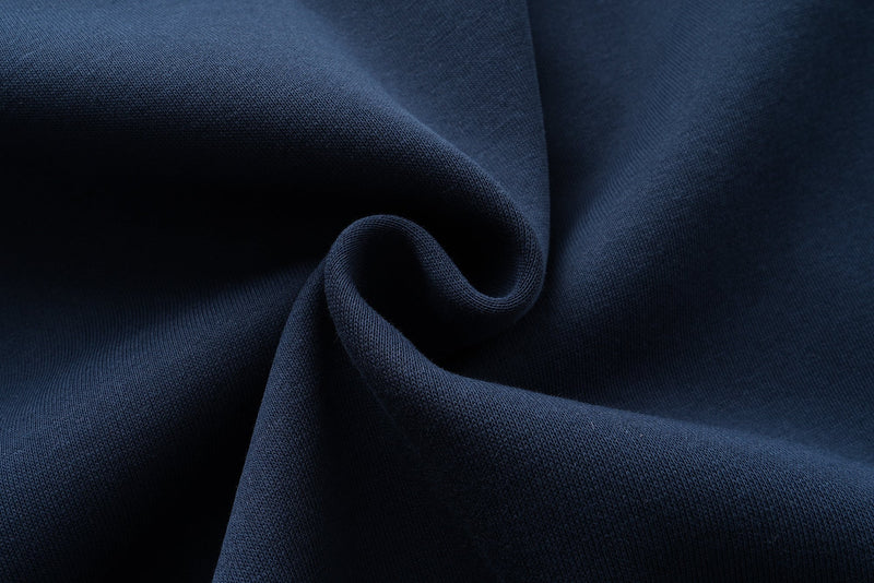 Close-up of navy fabric texture with soft folded drape