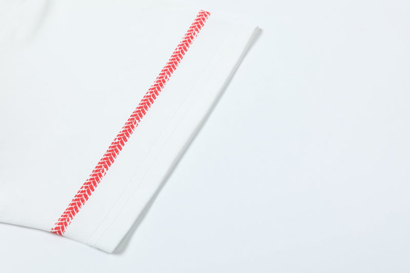 White soccer polo shirt sleeve with a red herringbone graphic stripe on a clean studio background