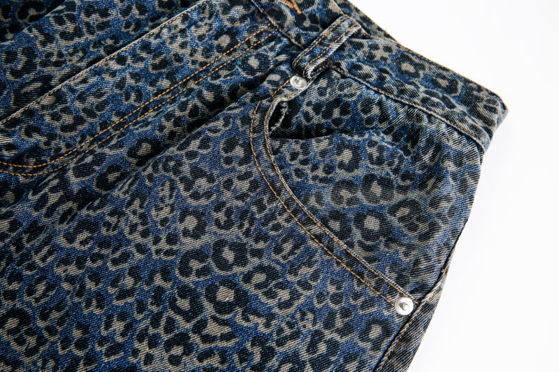 Close-up of blue leopard print jeans side seam and front pocket