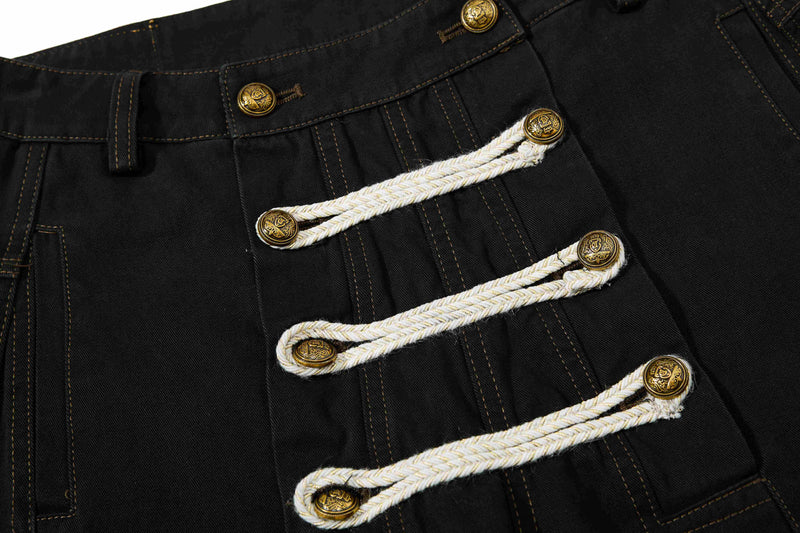 Close-up of black pants front with braided rope closures and brass buttons