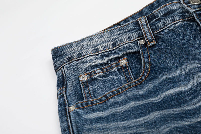 Close-up of front pocket and coin pocket on blue faded denim jeans