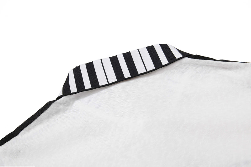 Close-up of a white men’s polo shirt with black trim and a striped collar, styled with a vintage streetwear look