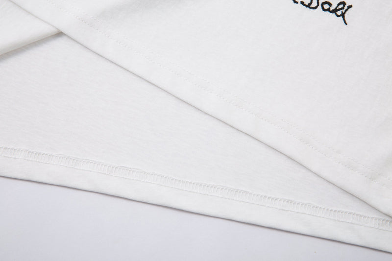 Close-up of white sleeve hem with visible stitching