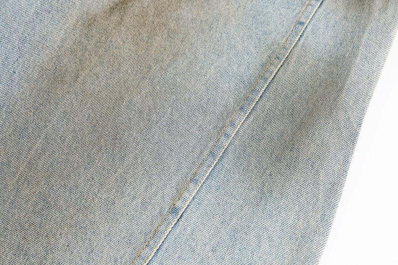 Close-up of smooth faded denim leg with diagonal seam detail