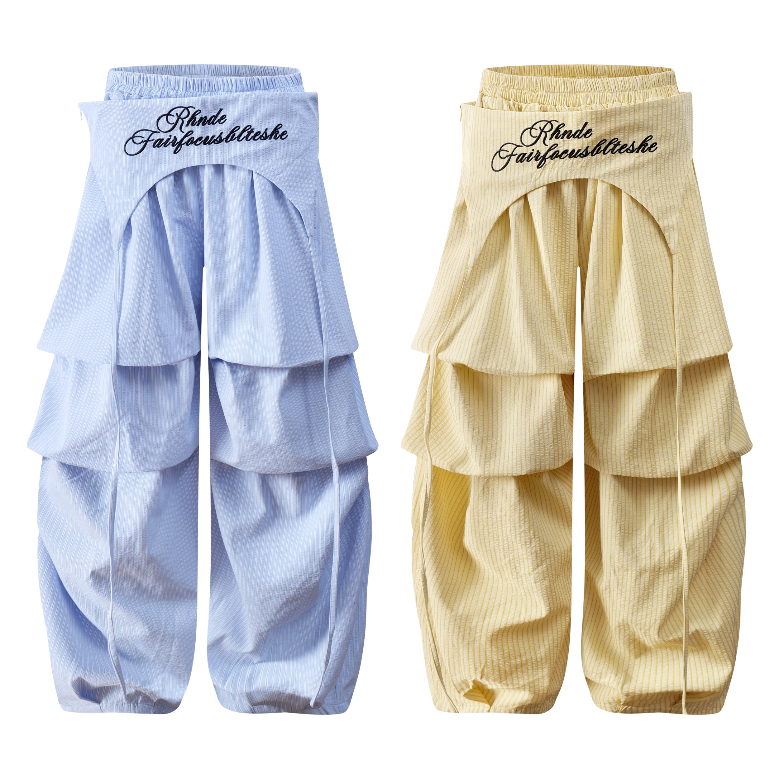 Light blue tiered layered pleated wide-leg pants with embroidered waistband and drawcord hem, front view