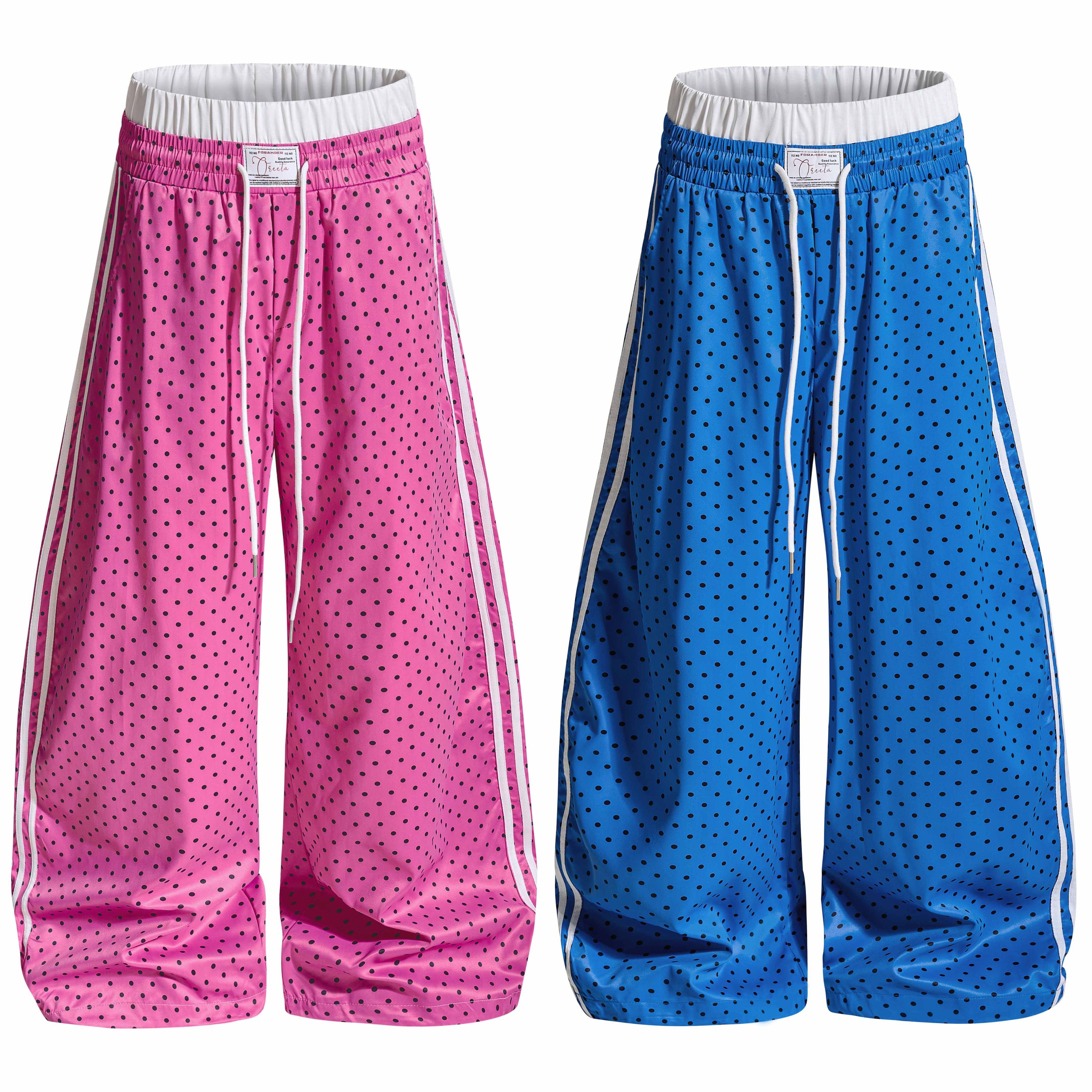 Pink and blue polka dot wide-leg track pants with white contrast side stripes and elastic drawstring waistband