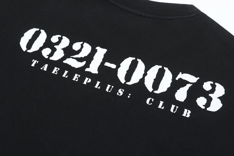 Close-up of black tee back with bold white 0321-0073 print