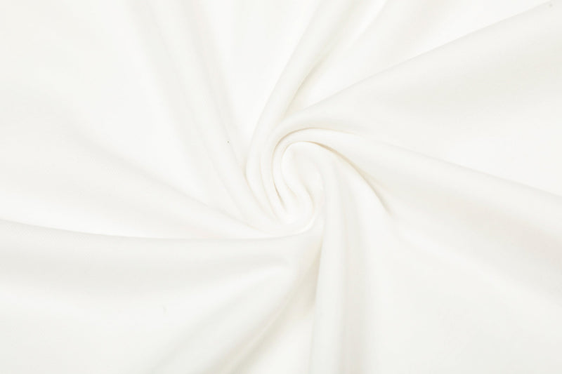 Close-up of white cotton fabric with gathered folds and subtle sheen
