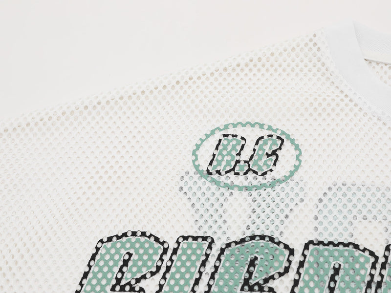 White mesh jersey tee with mint green and black varsity-style graphic lettering on textured perforated fabric