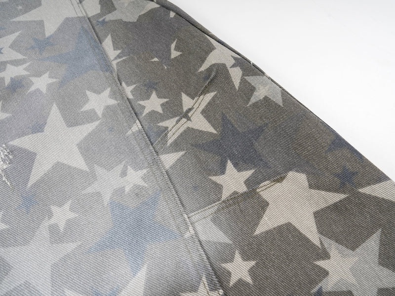 Close-up of side seam and star print on wide-leg denim pants