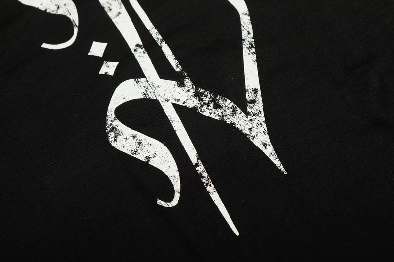 Close-up of stylized gothic lettering printed on black tee