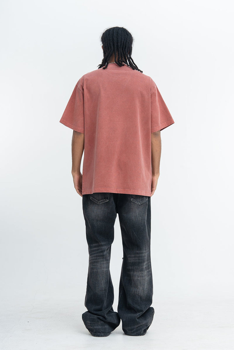 Vintage wash dusty rose oversized graphic T-shirt worn with black flared jeans, back view on a model