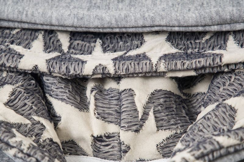 Close-up of star-patterned hood lining in gray and cream fleece hoodie