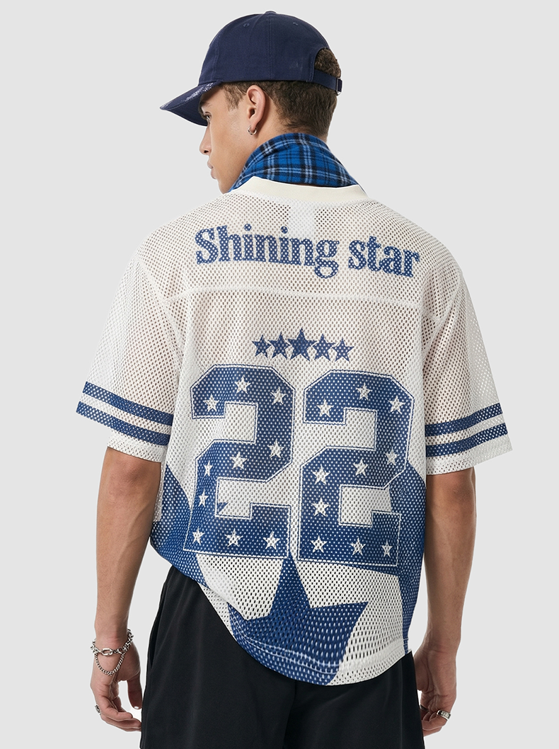 Back view of a white mesh jersey T-shirt with blue stars, number 22, and Shining Star graphic, styled with cap and plaid collar