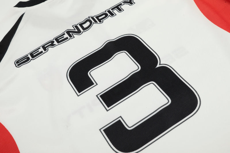 Close-up of large black number 3 and Serendipity text on white jersey back