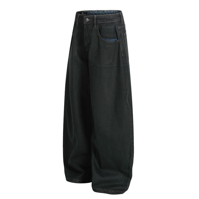 Black wide-leg denim pants angled front view showing the left side and curved silhouette